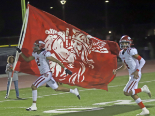 The Hueneme players take the field before the opening kickoff.
