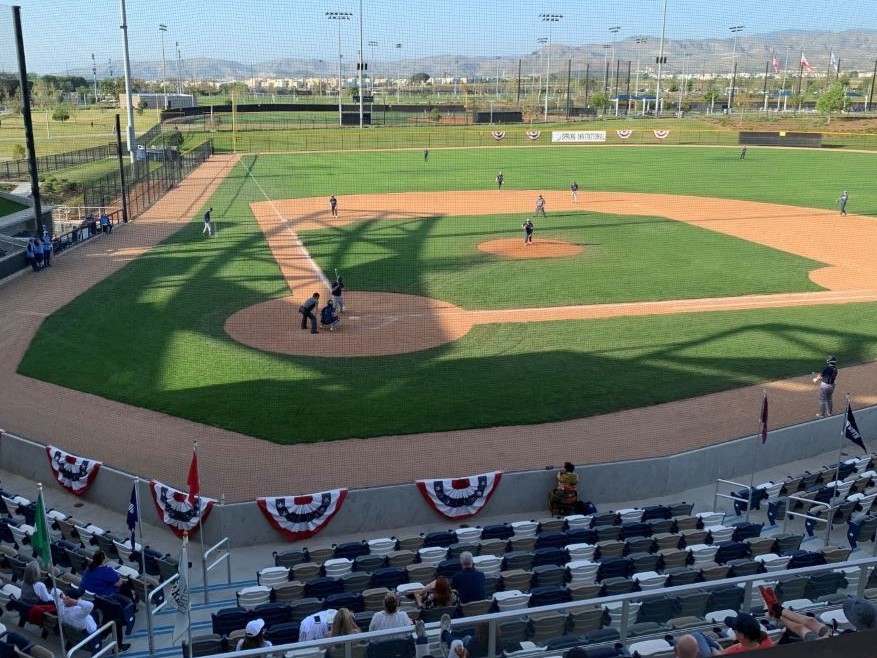 High school baseball coaches can use electronic devices to call pitches