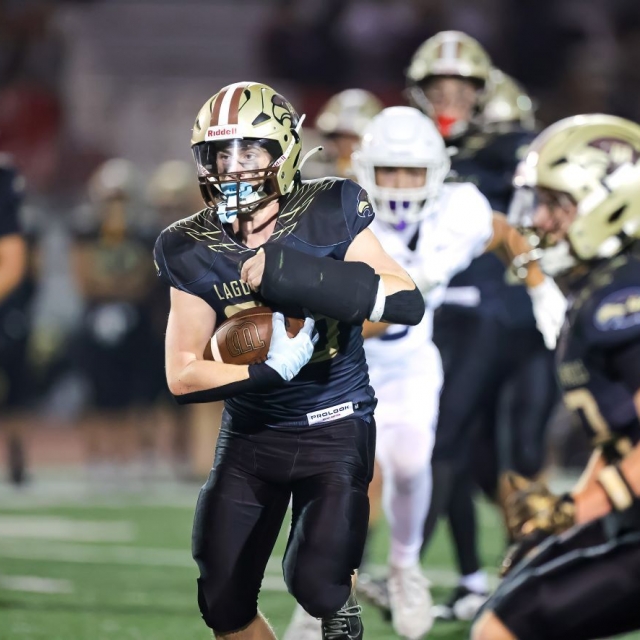 Laguna Hills’ Drew Meyers carries the ball for a Hawk’s touchdown