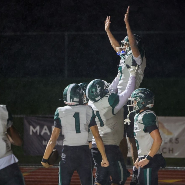 Buena Park players celebrate a touchdown by Joshua Santillan
