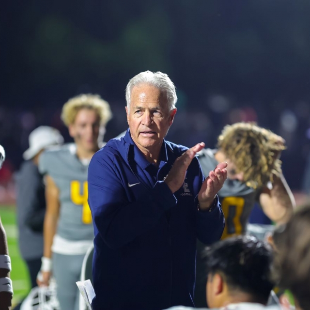 Saints Coach Rick Curtis consoles players and cheerleaders post game