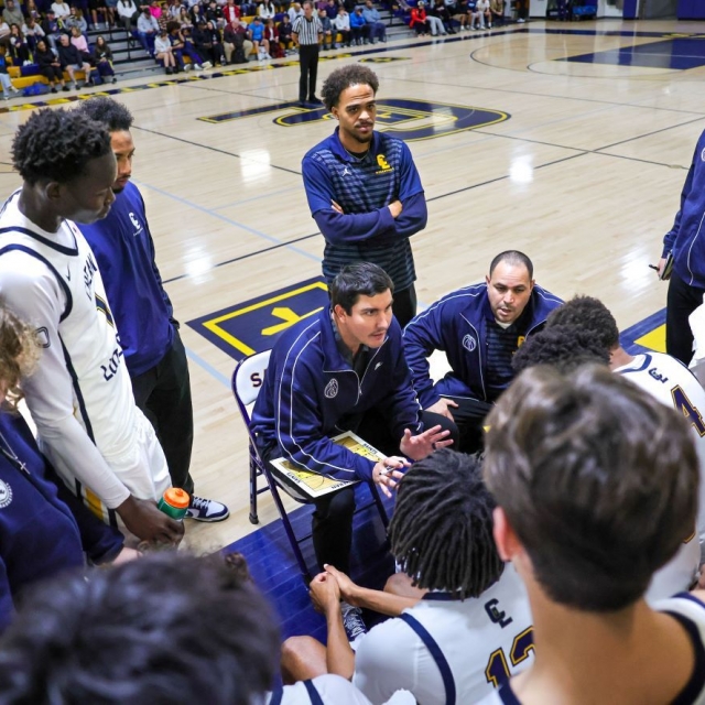 Crean Lutheran Coach Austin Loeb instructs players during a timeout