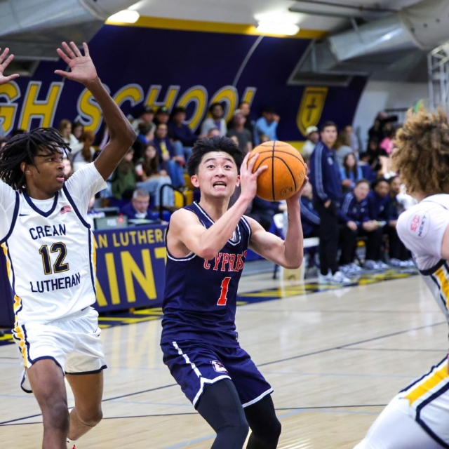 Cypress senior point guard Ryan Gov drives to the basket as Crean Lutheran’s Evan Mack and Nicholas Giarrusso defend