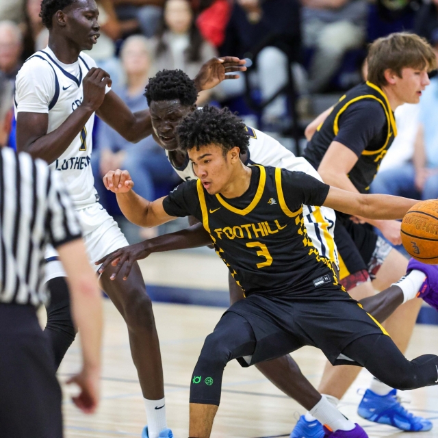 Foothill’s Braeden Davidson drives to the basket as Jacob Majok of Crean Lutheran defends