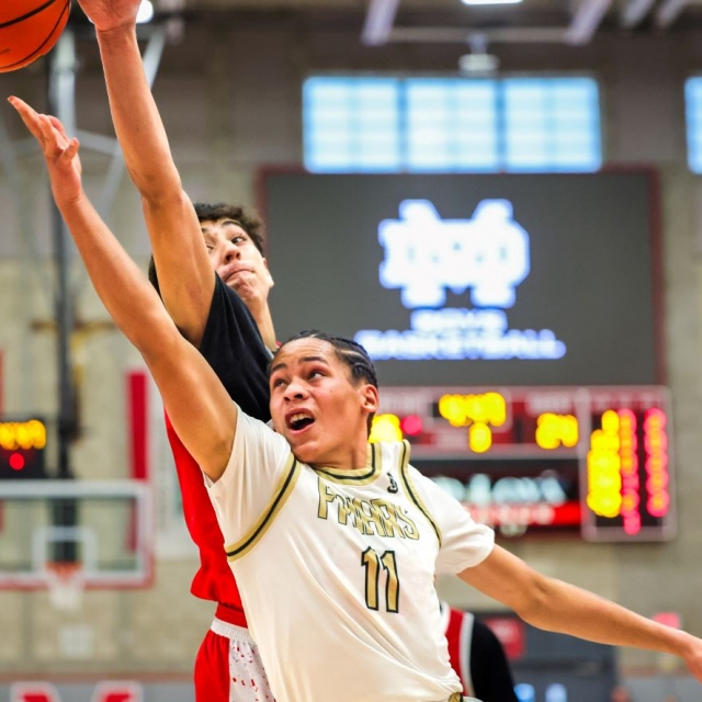Los Alamitos’s Alfredo Herrera defends a layup by Servite’s Tariq Johnson