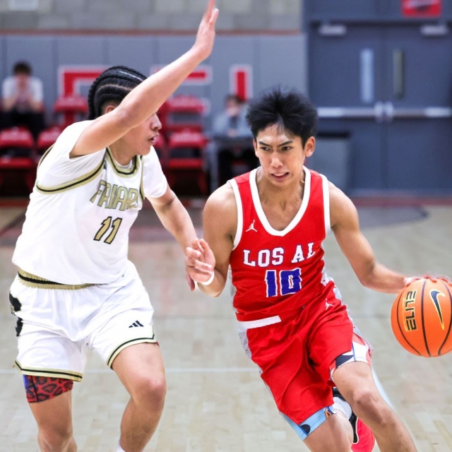 Los Alamitos’s Matt Lau is pressed by Servite’s Tariq Johnson