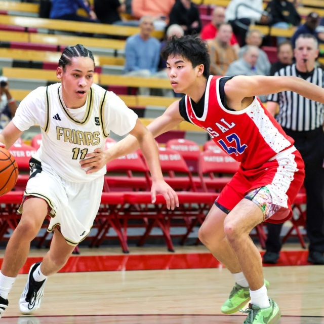 Servite’s Tariq Johnson is defended by Los Alamitos’s Ethan Lee