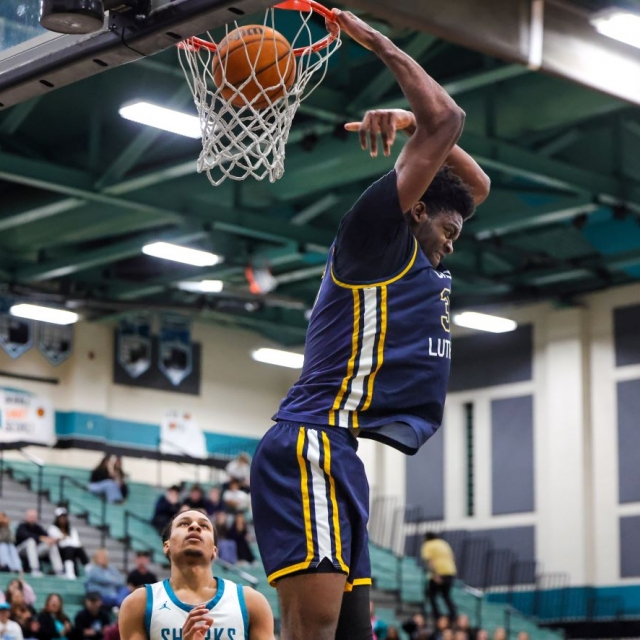 Chadrack Mpoyi of Crean Lutheran scores on a reverse dunk late in the game
