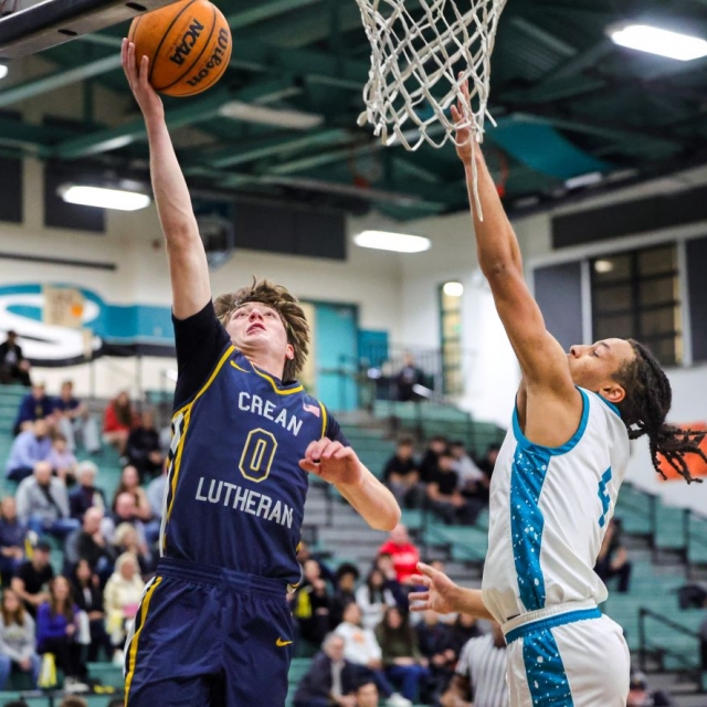Crean Lutheran’s Caden Jones drives to the basket as Santiago’s Jaden Berry defends
