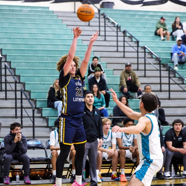 Crean Lutheran’s Nicholas Giarrusso attempts a three point shot as Santiago’s Matt Bernal defends