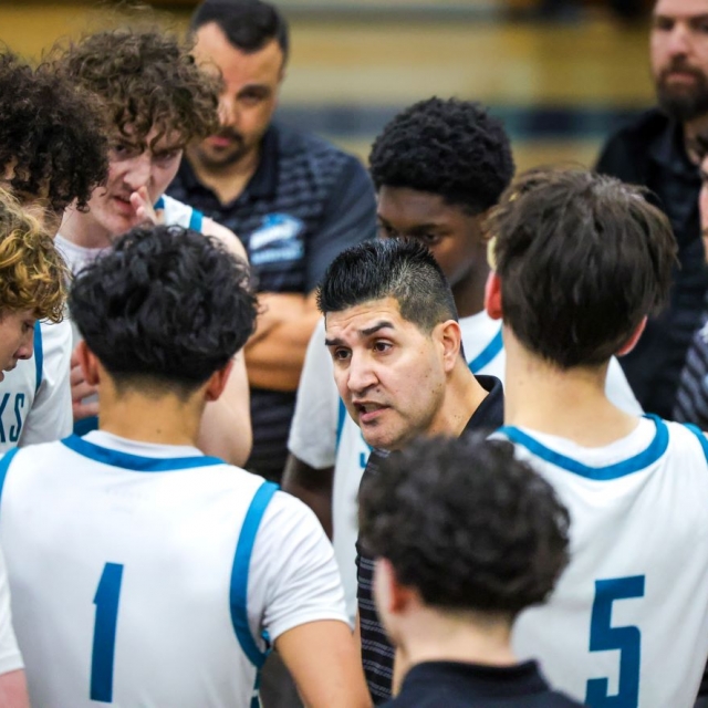 Santiago head coach Carlos Castillo talks to his players during a timeout