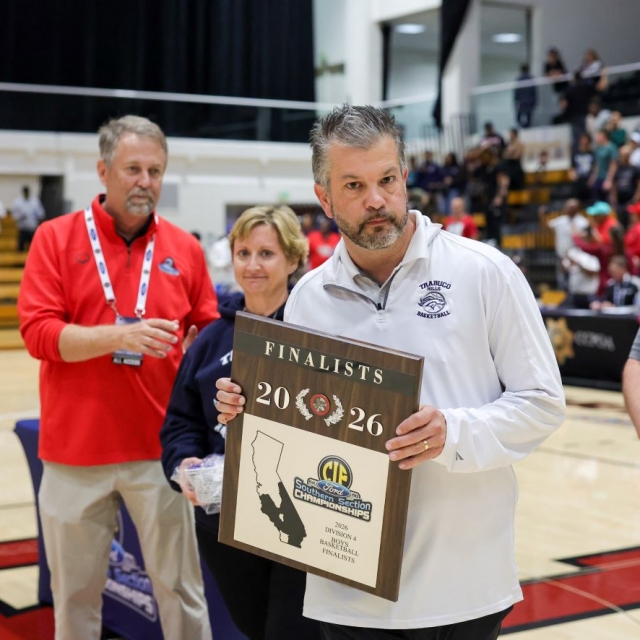 Trabuco Hills head coach Sean Sullens accepts the finalist plaque from CIF Commissioner Mike West