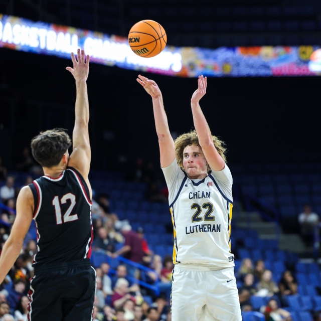 Nicholas Giarrusso of Crean Lutheran makes a three pointer as JSerra’s Hunter Frates defends