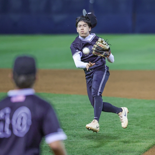 Jackson Arrasin of Laguna Beach flips the ball to first base for an out