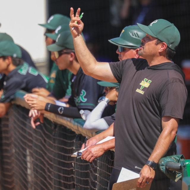 Rancho Alamitos coach Sammy Macias signals to the mound