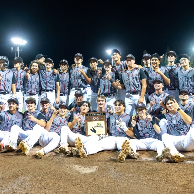 Shurr players and coaches pose with the Champions plaque