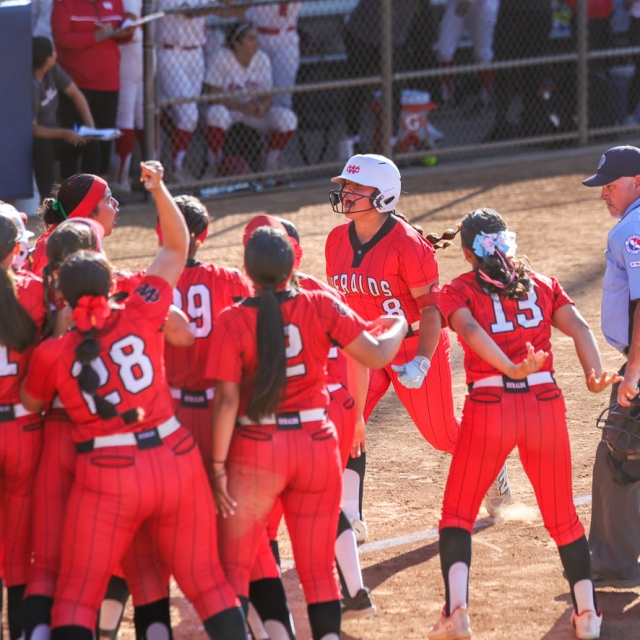Whittier Christian players await Mia Camacho at the plate