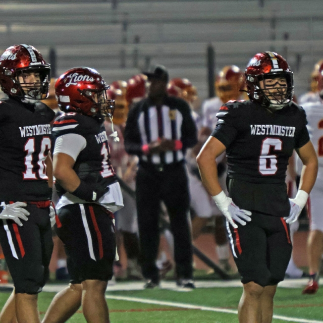 Members of the Westminster defense look over to the sidelines for instructions.